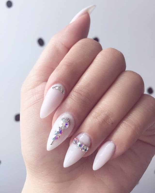 white nails with embedded diamonds